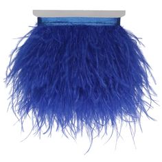 a blue bag with long feathers hanging from it's side on a white background