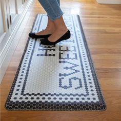 a woman in high heels standing on a rug