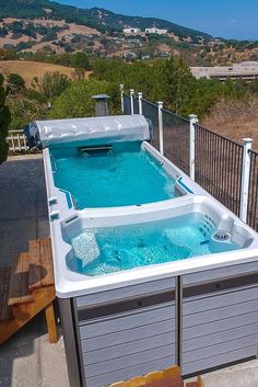 a hot tub sitting on top of a wooden deck