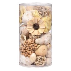 a vase filled with shells and flowers on top of a white table next to a wall