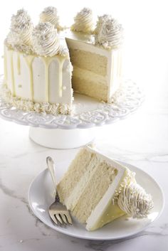 a slice of cake on a plate with a fork and knife next to the cake