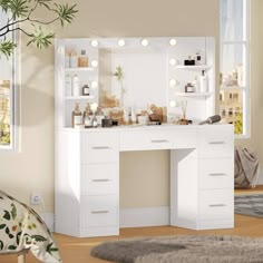 a white vanity with lights on it in front of a window and potted plant