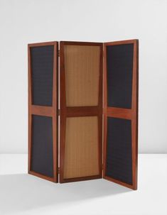 an empty room divider made out of wood and black fabric with three panels on each side