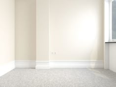 an empty room with white walls and carpeted flooring is seen in this image