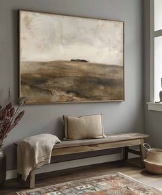 a painting hanging on the wall above a bench in a room with a rug and vase