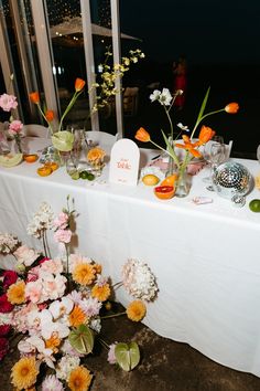 a table with flowers and vases on it