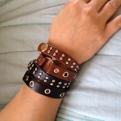 a woman's arm with several different bracelets on it