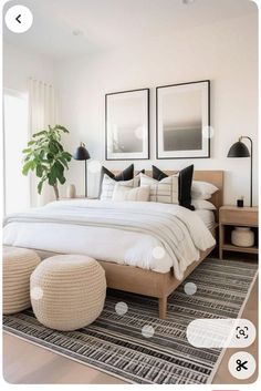 a white bedroom with black and white decor on the walls, two pictures above the bed