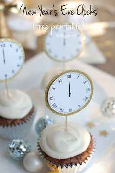 cupcakes with white frosting and gold decorations