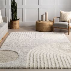 a living room with white walls and rugs