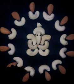 an intricately designed design made out of white and brown mushrooms on a black background