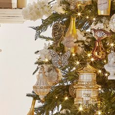 a christmas tree decorated with gold and white ornaments