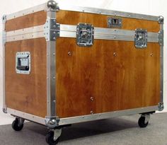 a large wooden trunk sitting on top of a gray carpeted floor next to a white wall