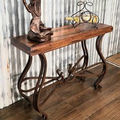 a wooden table with metal legs and a wine bottle on top