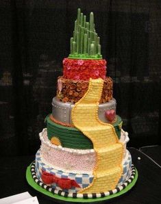 a multi - tiered cake is made to look like the wizard's castle