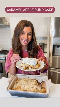 a woman is holding a plate with some food on it and the words caramel apple dump cake in front of her