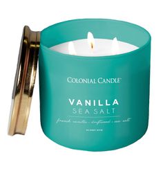 vanilla sea salt candle in a teal glass container with a gold lid and handle