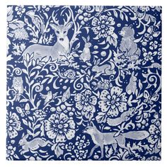 a blue and white wallpaper with deers, flowers and vines on the side