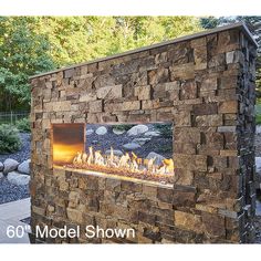 an outdoor fireplace with rocks and firewood in the background