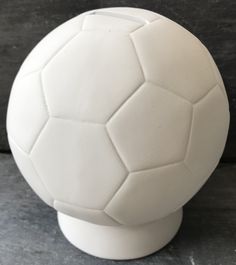 a white soccer ball sitting on top of a table