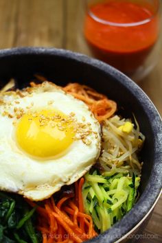 a bowl filled with vegetables and an egg