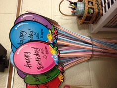 a bunch of balloons that are sitting in a vase with some writing on the balloons