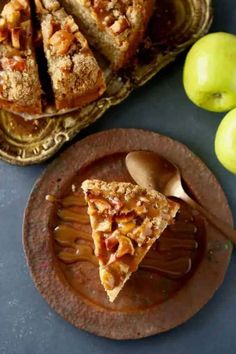 a slice of apple pie on a plate next to some apples