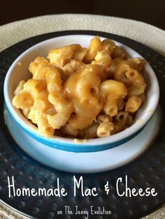 a bowl filled with macaroni and cheese on top of a plate