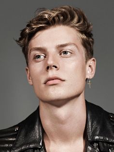 a young man wearing a black leather jacket