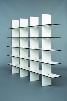 an empty shelf with several shelves on each side and one in the middle, against a gray background