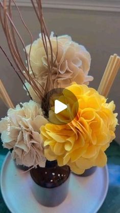 a vase filled with yellow flowers on top of a table