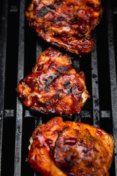 three pieces of meat cooking on top of a grill