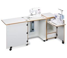 a sewing machine sitting on top of a table next to a white cabinet with drawers