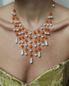 "This gorgeous crystal waterfall necklace was crafted from fine Czech crystal in 1950s. The crystals are beautifully faceted, in orange and a milky ivory hue, on a silver chain- the color combination is so unique; I've never seen one quite like it and I'm not sure I will again! The waterfall of drops cascades across the décolletage for an outfit-defining moment. Closes with a spring clasp, and it can attach to any link, so the length is very adjustable, about 16\" to 18.5\"; drop at longest poin Vintage Orange Jewelry With Faceted Beads, Orange Vintage Jewelry With Faceted Beads, Vintage Orange Necklace With Faceted Beads, Vintage Orange Necklaces With Faceted Beads, Orange Vintage Necklace With Faceted Beads, Waterfall Necklace, Czech Crystal, Color Combination, Vintage 1950s