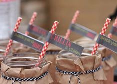 mason jars with striped straws and labels on them are ready for guests to enjoy