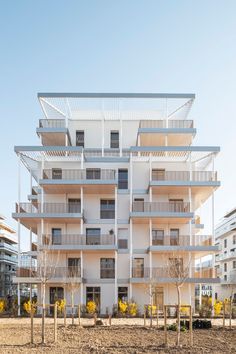 an apartment building with white balconies and balconies