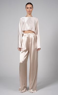 Our Paris Pant is a high-waisted, wide-leg pant made from 100% polyester. Simple, yet elegant the silky look elevates the overall appearance of the pant. The small touches such as pleats and the front zipper closure make them all the more unique. Neutral Elegant Outfit, Silk Cargo Pants Outfit, Satin Set Outfit, Silk Pants Outfit, Pisces Style, Neutral Wardrobe, Baddie Vibes, Silky Pants, Silk Wide Leg Pants