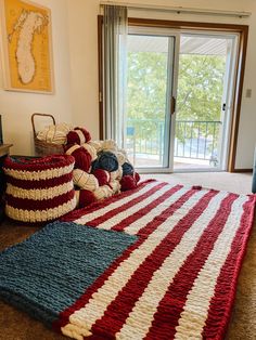 there is a large bed with red, white and blue crocheted bedspread