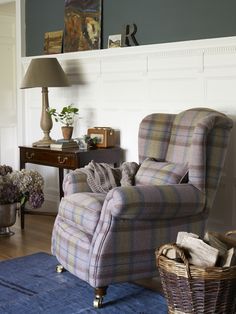 a living room with a plaid chair and blue rug