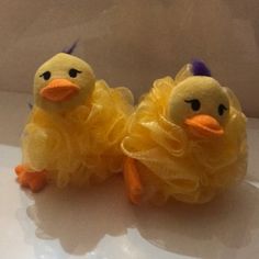 two yellow stuffed chickens sitting next to each other