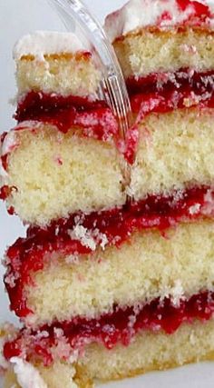 a close up of a slice of cake on a plate with a fork in it