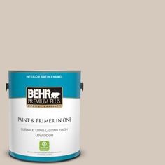 a can of behr premium plus paint and primer in one on a blue background