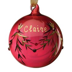 a red ornament with gold lettering on it