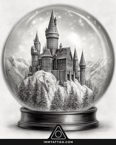 a snow globe with an image of a castle in the middle and mountains behind it