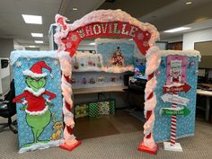 an office cubicle decorated for christmas with dr seuss and the grinch theme