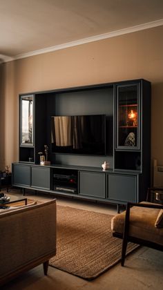 a living room filled with furniture and a flat screen tv on top of a wooden entertainment center