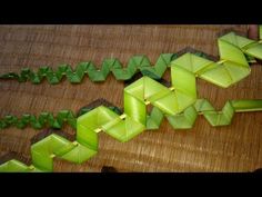 some green origami pieces on a wooden table