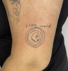 a woman with a tattoo on her arm saying it's little world and an image of elvis presley