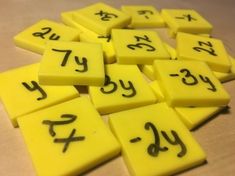 yellow and black numbers are arranged in rows on a wooden surface with one number missing