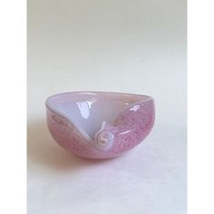 a pink and white bowl sitting on top of a table